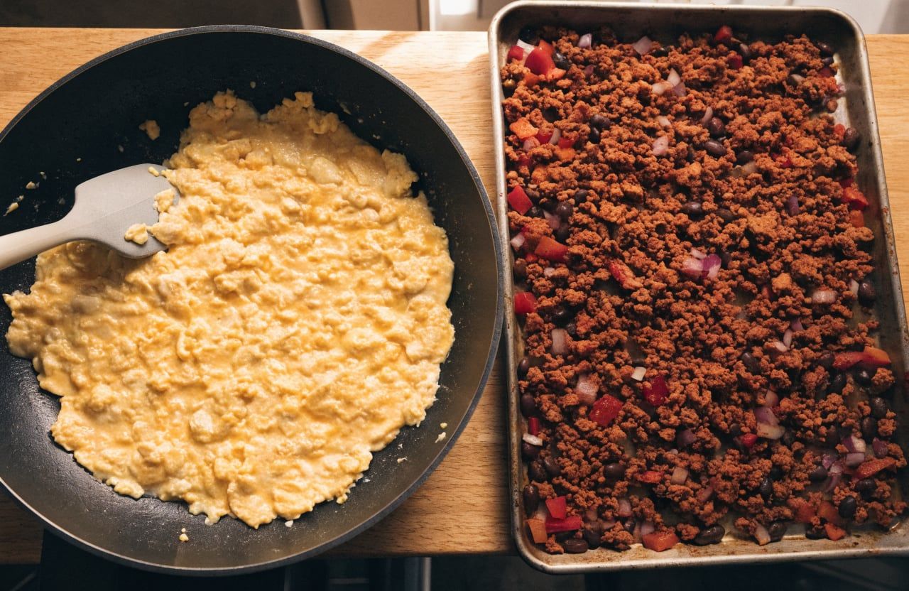 Large soft curds of scrambled eggs, still glossy, in a nonstick skillet
