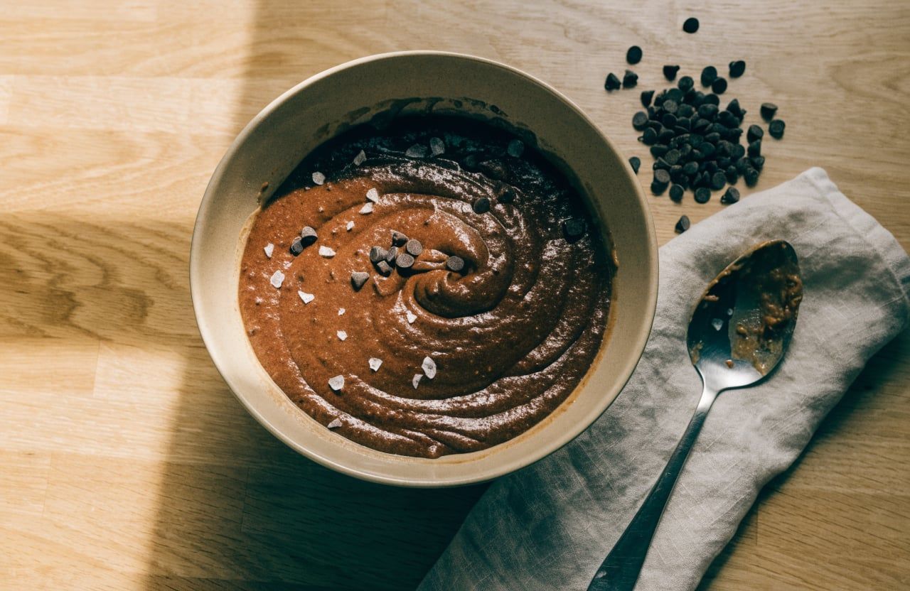 Finished protein brownie batter with chocolate chips folded in and scattered on top